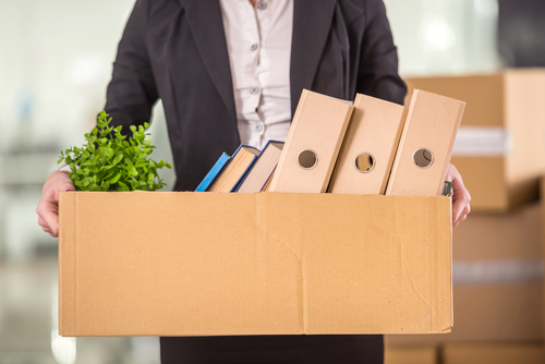 Close Up.,smiling,young,businesswoman,holding,cardboard,box,with,her,things.