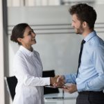 Two,happy,confident,diverse,business,people,shaking,hands,in,office,