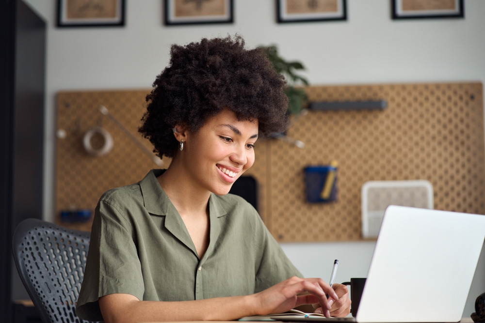 Young,adult,happy,african,american,girl,student,using,computer,learning