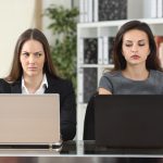 Front,view,of,two,angry,businesswomen,looking,each,other,with